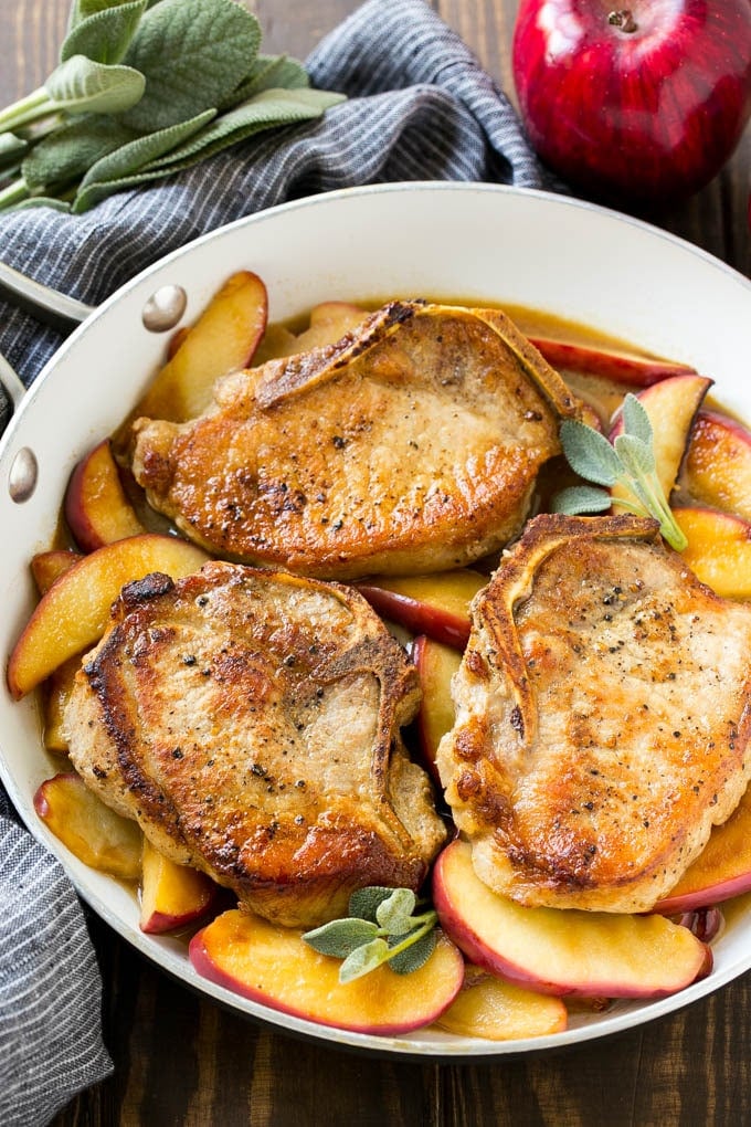 Apple pork chops with cider and sage in a skillet.
